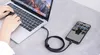 A person's hands are typing on a laptop, which is connected by a USB-C cable to a smartphone displaying photos. Podgląd zdjęcia produktu