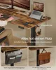 A person using a standing desk with various accessories attached. Produktbild-Vorschau