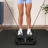 A person is using a piece of exercise equipment in a room. Voir les images du produit