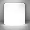 A white, square-shaped ceiling light with rounded corners is shown against a gray wall and floor. Anteprima dell’immagine prodotto