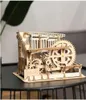 A wooden mechanical model on a dark surface. Podgląd zdjęcia produktu