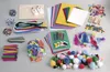 A collection of craft supplies laid out on a light gray surface. Produktbild-Vorschau