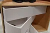 A close-up view of a multi-layered organizer with white drawers and a natural wood exterior. Náhled obrázku produktu
