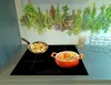 A kitchen scene with a stovetop and food. Produktbild-Vorschau