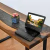 A portable DVD player is open and displaying a scene on its screen, placed on a wooden table with a decorative flower arrangement. Podgląd zdjęcia produktu