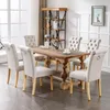 A dining room set with a wooden table and six chairs. Produktbild-Vorschau
