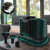 A carpet cleaner and its accessories are displayed on a wooden table in a living room setting. Produktbild-Vorschau