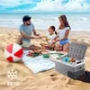 A family having a picnic on the beach with a cooler. Náhled obrázku produktu