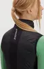 Close-up of a woman from behind wearing a black vest over a green long-sleeved shirt. Podgląd zdjęcia produktu
