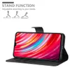 A black phone case with a phone inside displaying a colorful wallpaper, shown in a stand function. Anteprima dell’immagine prodotto