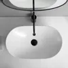 A top-down view of a white oval washbasin with a black faucet and drain. Náhľad obrázku produktu