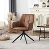 A brown upholstered swivel chair with a black base is placed on a rug in a room with a cabinet and a lamp. Produktbild-Vorschau