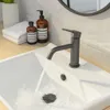 A close-up view of a bathroom sink with a faucet running water. Náhled obrázku produktu
