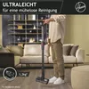 A person is holding a Hoover cordless vacuum cleaner in a living room setting. Produktbild-Vorschau