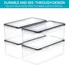 A stack of clear plastic storage containers with black lids. Produktbild-Vorschau