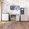 A child's bedroom set with a dresser, desk, and wardrobe against a wall with deer and floral wallpaper. Náhľad obrázku produktu