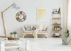A living room scene with a sofa, a floor lamp, a shelf, and a clock on the wall. Anteprima dell’immagine prodotto