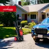A pressure washer and a blue car are parked in front of a house. Produktbild-Vorschau