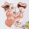 Rosenquarz- und klare Konfetti-Luftballons in Stern-, Herz- und runden Formen, mit einer Pflanze und Büchern im Hintergrund Náhled obrázku produktu