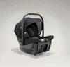 A black Joie Signature Sprint baby car seat with a brown handle is shown against a light gray background. Produktbild-Vorschau