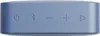 A close-up view of the top surface of a blue portable speaker, showing control buttons. Produktbild-Vorschau