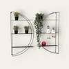 Two black metal wall shelves with decorative items. Produktbild-Vorschau