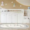 A white loft bed with storage drawers and stairs, set in a child's room with decorative hot air balloons and clouds on the wall. Produktbild-Vorschau