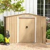 A tan metal shed with double doors, a yellow pressure washer, and gardening tools in a yard. Podgląd zdjęcia produktu