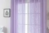 A close-up of sheer lilac curtains hanging in front of a window. Produktbild-Vorschau