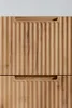 A close-up view of two drawers of a wooden cabinet with a ribbed texture and integrated handles. Náhľad obrázku produktu