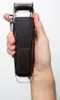 A hand holds a Remington hair clipper against a white background. Podgląd zdjęcia produktu