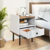 A bedside table next to a bed. Podgląd zdjęcia produktu
