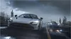 Two sports cars driving on a wet road in a desert landscape during a storm. Produktbild-Vorschau