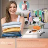 A woman is holding folded laundry in front of a drying rack with clothes on it, in a laundry room setting. A piggy bank graphic is in the upper right corner. Produktbild-Vorschau