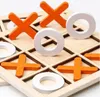 A close-up view of a wooden tic-tac-toe game board with orange 'X' pieces and white 'O' pieces. Náhled obrázku produktu