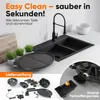A kitchen counter with a sink and a grill, along with a display of grill accessories. Produktbild-Vorschau