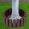 A tree surrounded by a brown palisade border in a grassy yard. Náhled obrázku produktu