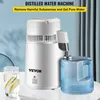 A distilled water machine is shown on a table with a glass of water and a collection jug. Náhľad obrázku produktu
