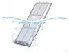 A vacuum cleaner filter is being submerged in water, with splashes and bubbles indicating the cleaning process. Produktbild-Vorschau