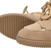A close-up view of two beige boots with fluffy lining and laces. Produktbild-Vorschau