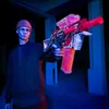 A young person holding a toy gun in a dimly lit, industrial-looking space with blue and pink lighting. Voir les images du produit