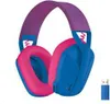 A pair of blue and pink headphones with a purple headband, shown from a slightly angled front view, with a small blue USB dongle to the right. Náhľad obrázku produktu