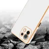 A white and gold phone case is shown on a cracked, dark gray surface with a blurred white background. Produktbild-Vorschau