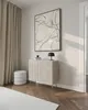 A modern living room setting featuring a chest of drawers, a stool, and artwork. Produktbild-Vorschau
