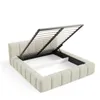 A bed frame with its storage compartment open, showing the slatted base and internal storage space. Voir les images du produit