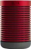 A red and black cylindrical speaker with a gray base. Náhled obrázku produktu