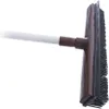 A close-up view of a broom with a white handle and brown head with black bristles. Náhled obrázku produktu
