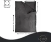 A flat lay of a dark gray duvet cover and pillowcase set, with dimensions indicated by measurement lines and text. Produktbild-Vorschau