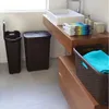 A bathroom scene with laundry baskets and a sink. Podgląd zdjęcia produktu