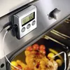 A close-up shot of a digital oven thermometer inserted into a roasted chicken in an oven. Anteprima dell’immagine prodotto
